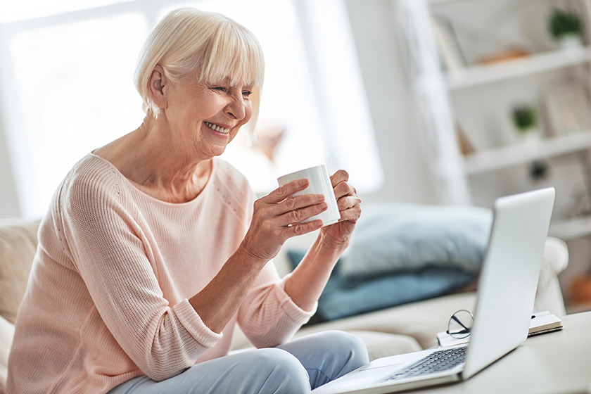 laughing-senior-caucasian-woman-sitting-sofa